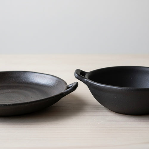 Two Japanese style ceramic bowls on a dining table