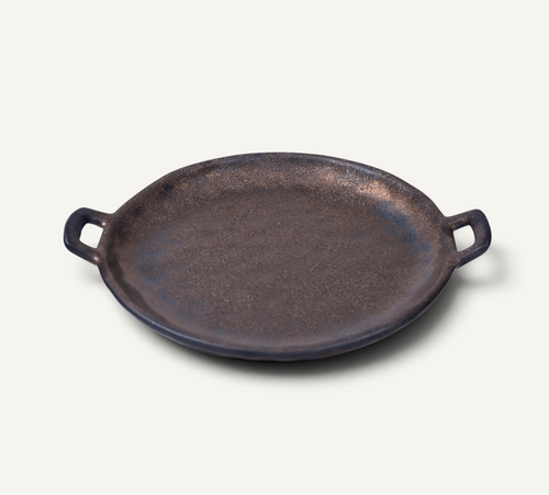 A Japanese style ceramic platter in bronze finish with side handles, photographed on a clean off-white background.