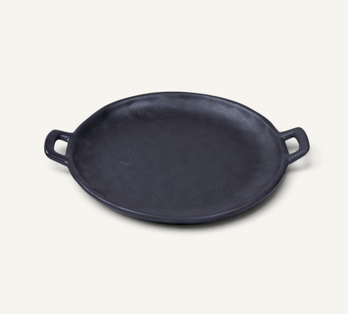 A Japanese style ceramic platter with side handles, photographed on a clean off-white background.