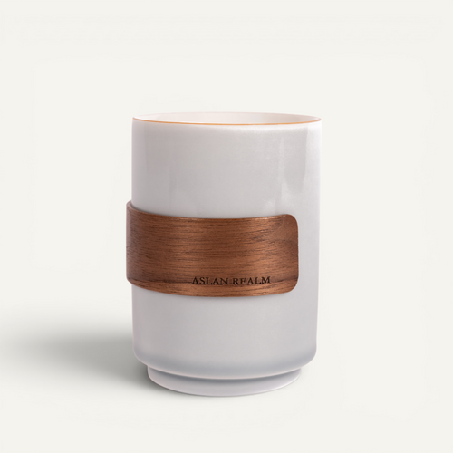 A ceramic white cup with a bamboo sleeve, featuring the brand name 'Aslan Palm' on the bamboo label.