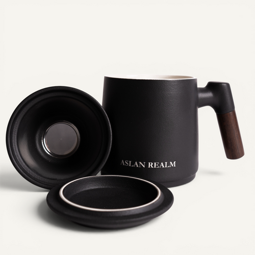 A black ceramic infuser mug with a walnut handle and a matching lid, branded with 'ASLAN REALM'.