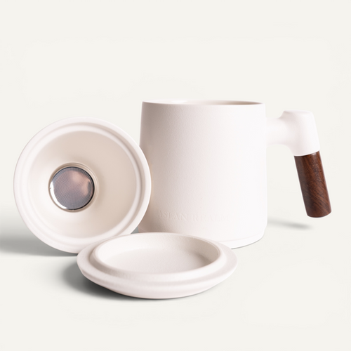 A black ceramic infuser mug with a walnut handle and a matching lid, branded with 'ASLAN REALM'.