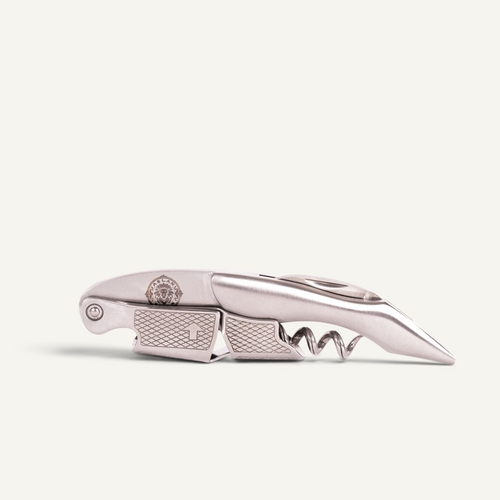 A silver-toned stainless steel corkscrew knife with a textured handle and a partially extended corkscrew, shown on a clean off-white background.