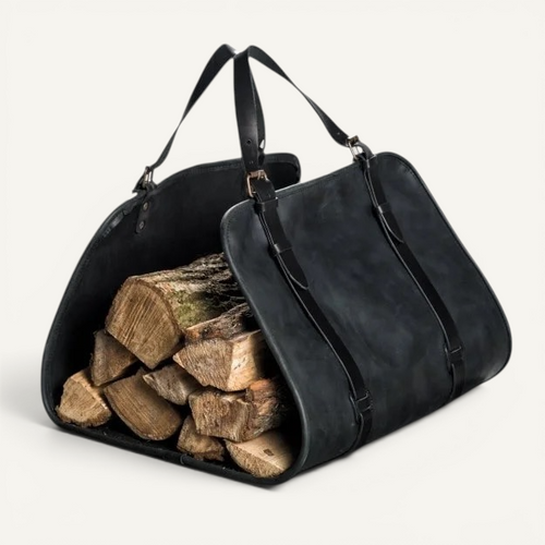 Man carrying a black full-grain leather firewood carrier beside an open vehicle in a forest