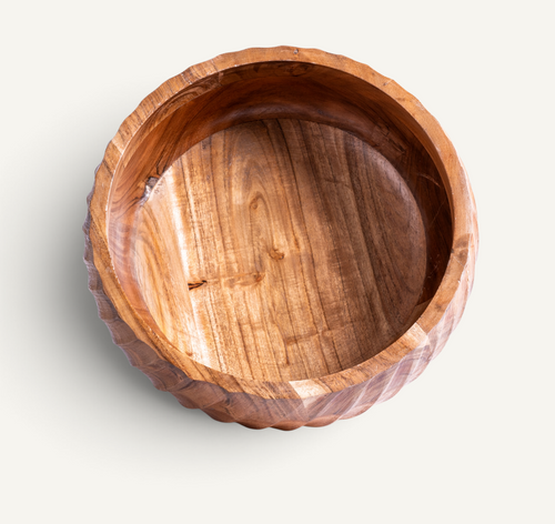 A round acacia bowl with a scalloped, fluted rim, shown from a top-down perspective on a light off-white background.