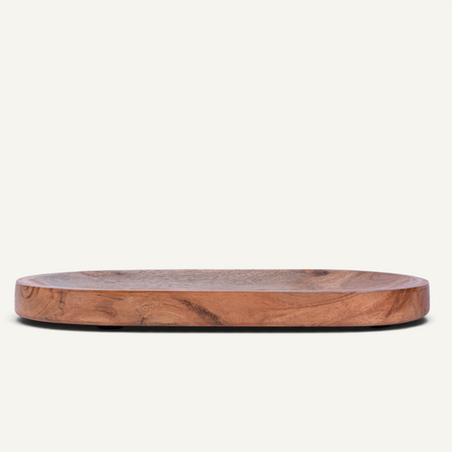 An oval wooden serving board with a natural grain pattern, shown on a plain off-white background.