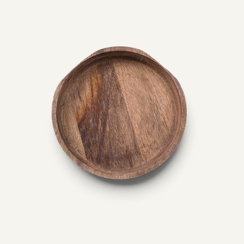 A round wooden bowl with a natural wood grain pattern, photographed from directly above on a light off-white background.