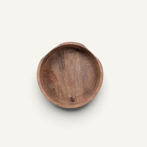 A round wooden bowl with a natural brown wood grain, photographed from a top-down perspective on a light off-white background.