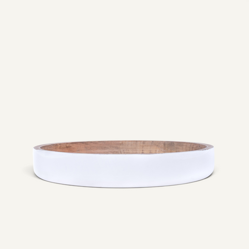 A minimalist white circular bowl with a wooden interior, shown with its matching lid propped behind it on a clean off-white background.