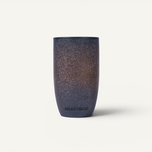 Four ceramic tumblers with gradient finishes on a white background