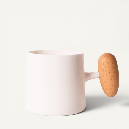 A white ceramic mug with a beech wood handle on a plain background.