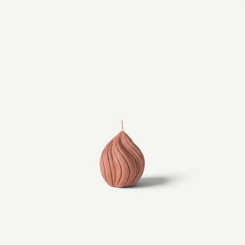 A ribbed helix-shaped candle in a warm clay color, displayed on a clean off-white background.