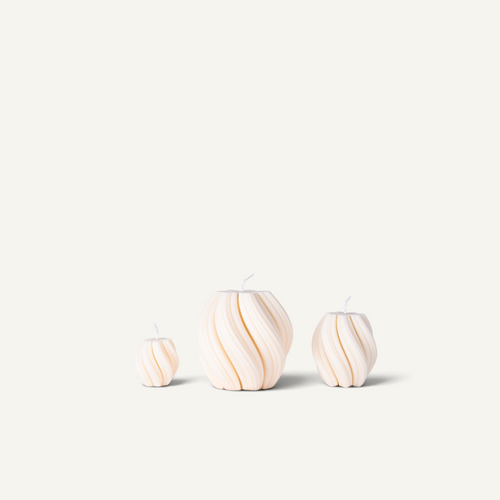 Three spiral-patterned pillar candles in cream and white, displayed in a size progression from smallest to largest against a solid off-white background.