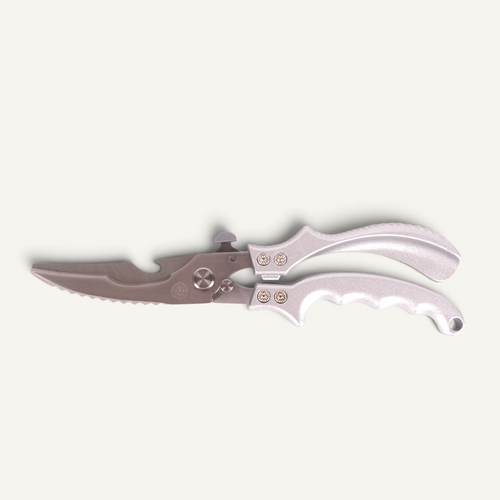 Stainless steel poultry shears on a white background