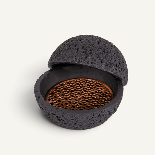A Michelin style food presentation bowl with volcanic texture and copper tray