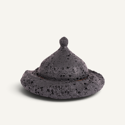 A Michelin style food presentation plate with volcanic texture and copper tray